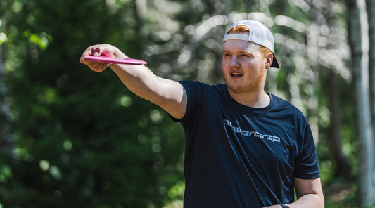Young disc golfer aiming a shot